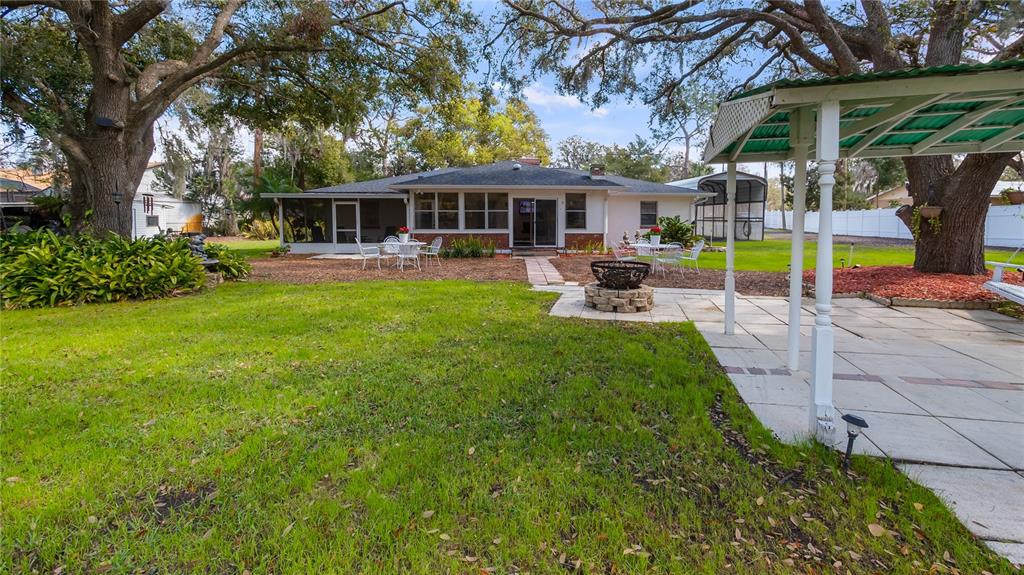 11136 Bronson Road Clermont, FL 34711 - Photo 22 of 29 a view of a house with backyard porch and sitting area