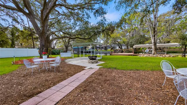 a view of a house with swimming pool and sitting area
