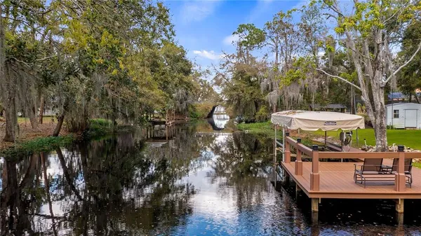a view of a patio with table and chairs and a barbeque