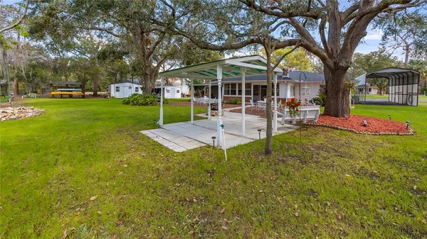 a view of a house with backyard porch and sitting area