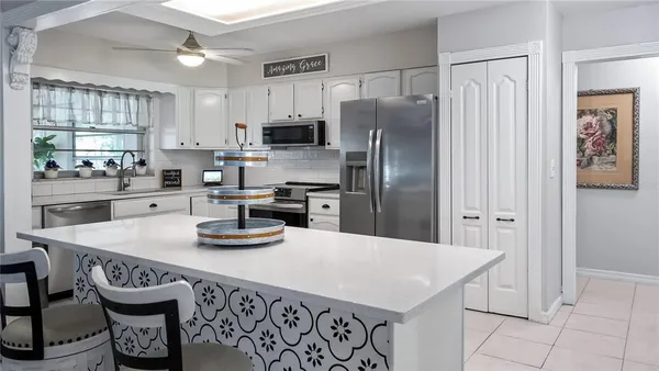 a kitchen with stainless steel appliances a refrigerator and a sink