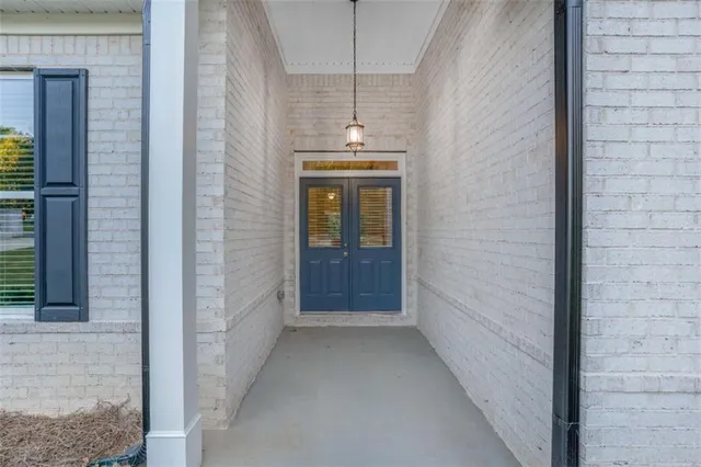 a view of a hallway with wooden walls and windows