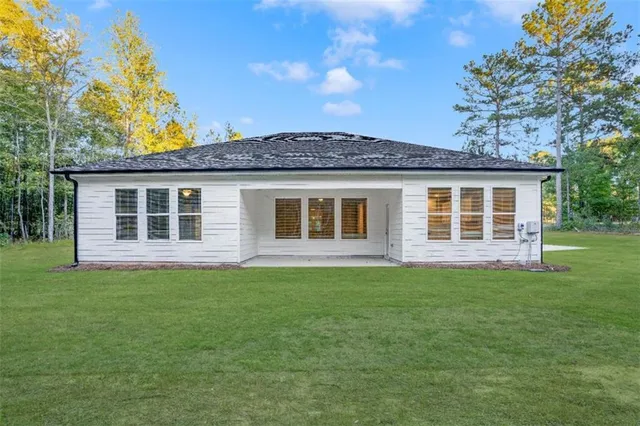 a front view of a house with a garden
