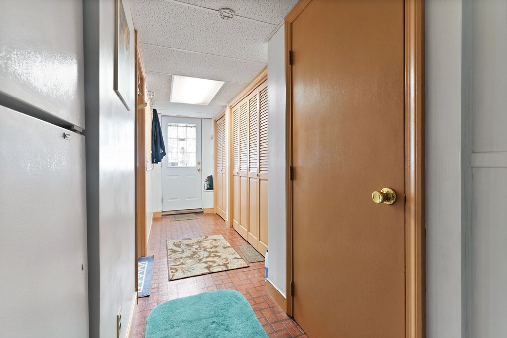 4 Peters Road Canton, MA 02021 - Photo 34 of 34 a view of a hallway with wooden floor and a livingroom