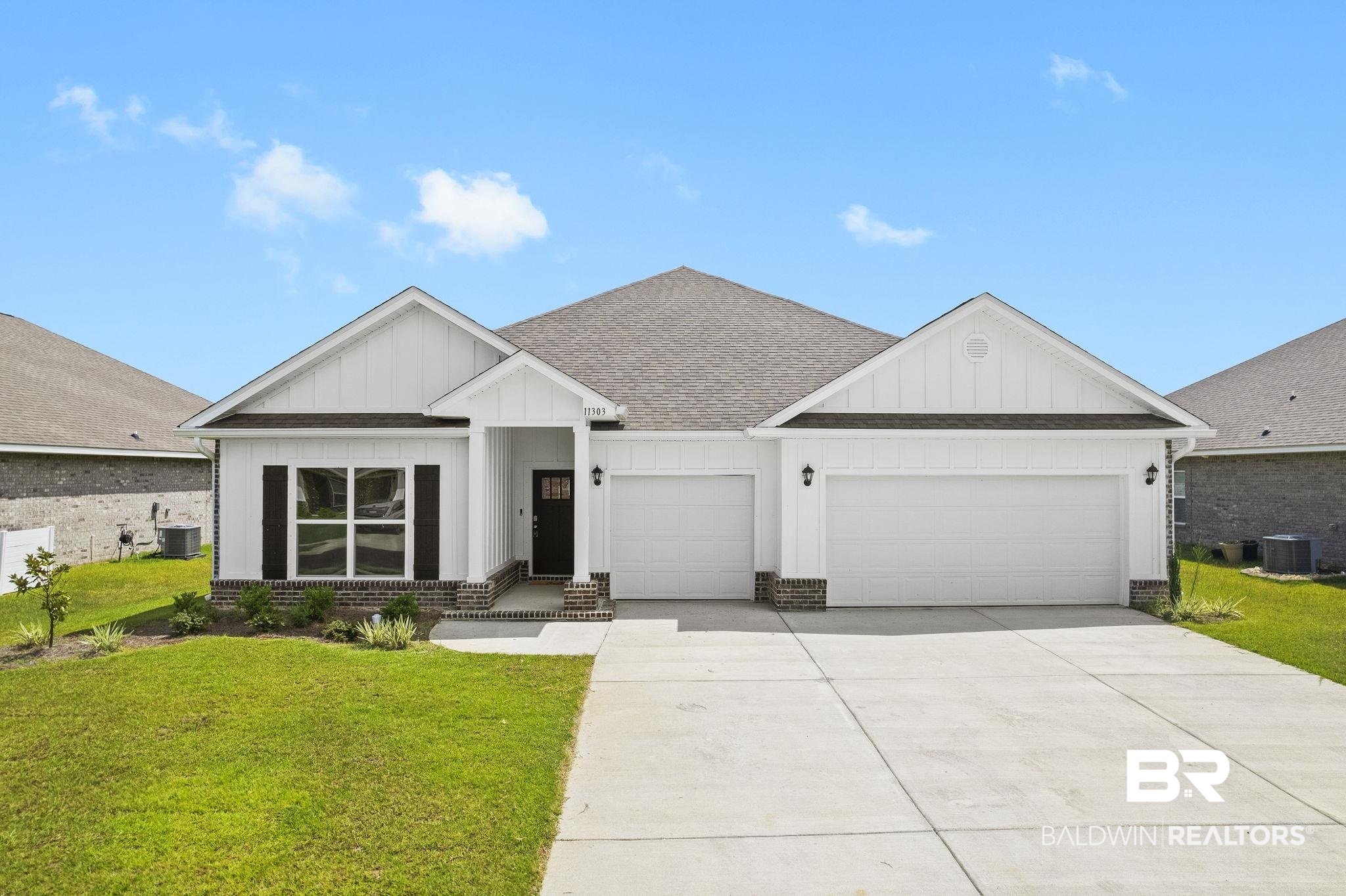 11303 Genuine Risk Circle Daphne, AL 36526 - Photo 81 of 100 View of front of house featuring a garage, central AC unit, and a front lawn