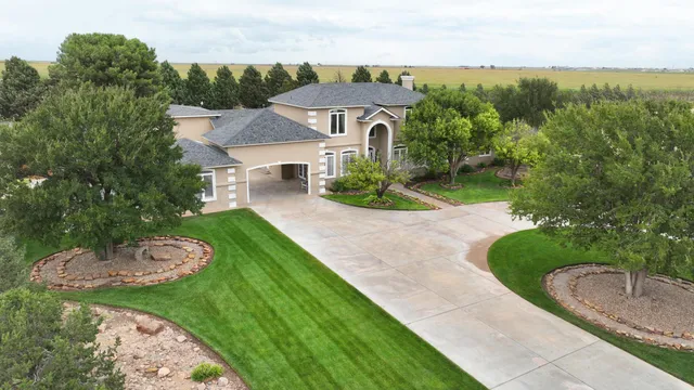 an aerial view of a house with garden space and street view
