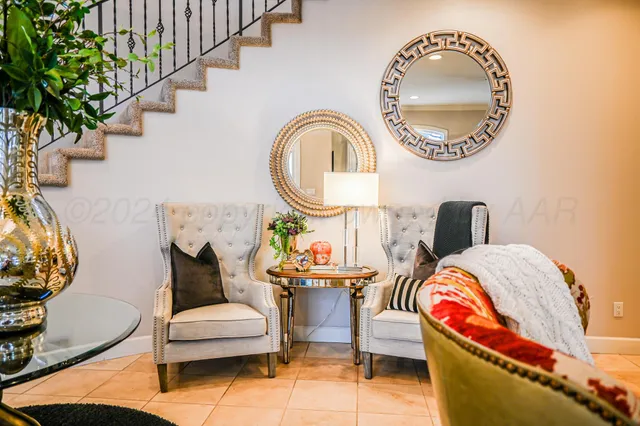 a view of a hallway with a couch and a view of bathroom