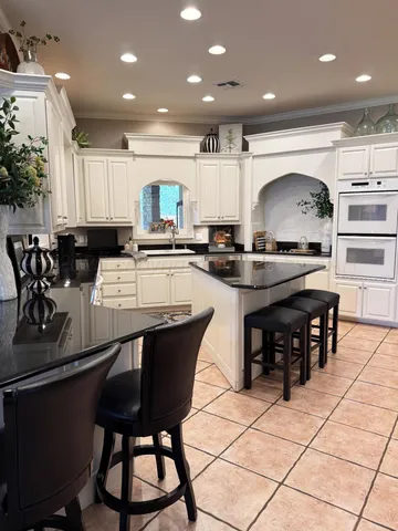 a bedroom with furniture and a large window