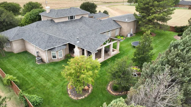 a kitchen with granite countertop a stove a sink and a microwave