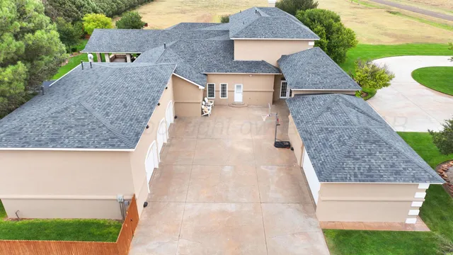 a living room with furniture and floor to ceiling windows