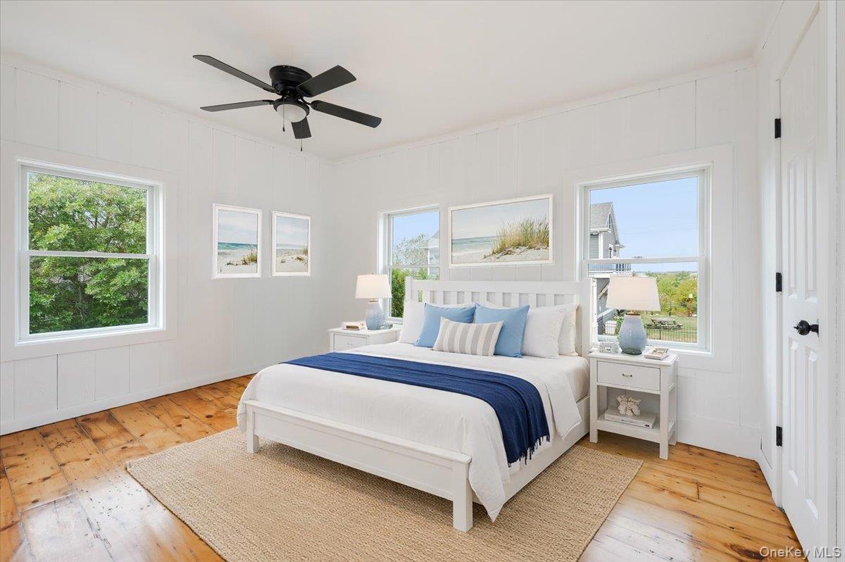 56 Oak Beach Road Babylon, NY 11702 - Photo 19 of 34 a bedroom with a bed and wooden floor