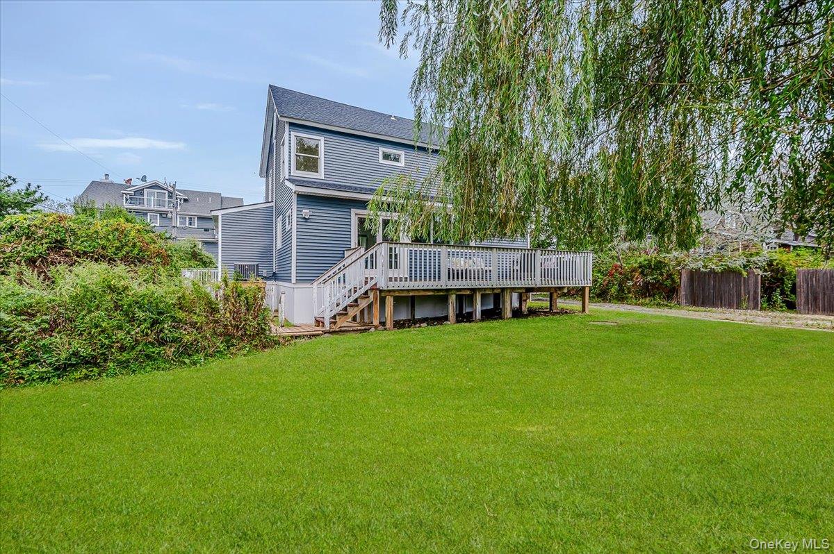 56 Oak Beach Road Babylon, NY 11702 - Photo 27 of 34 a view of a house next to a big yard and large trees