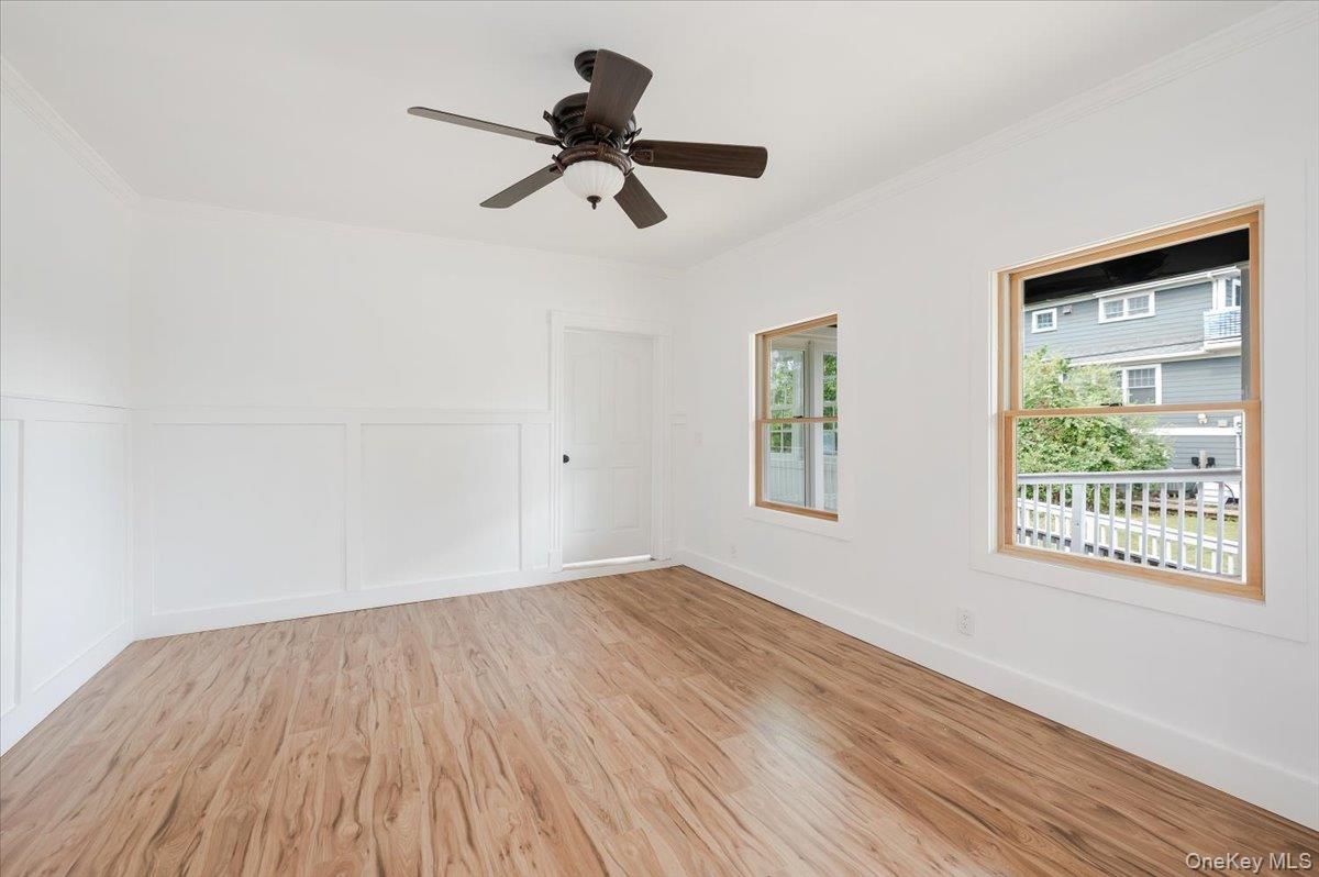 56 Oak Beach Road Babylon, NY 11702 - Photo 7 of 34 a view of empty room with wooden floor and fan