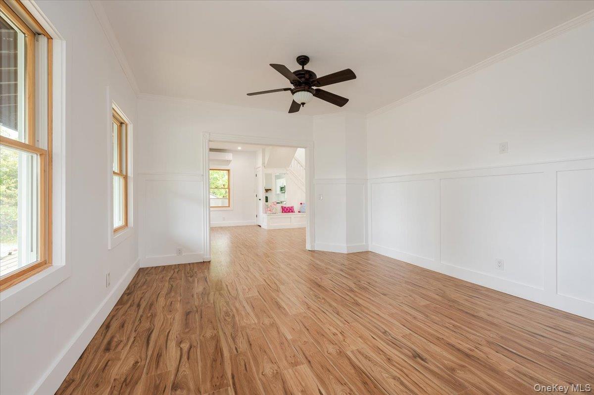 56 Oak Beach Road Babylon, NY 11702 - Photo 8 of 34 wooden floor in an empty room with a window