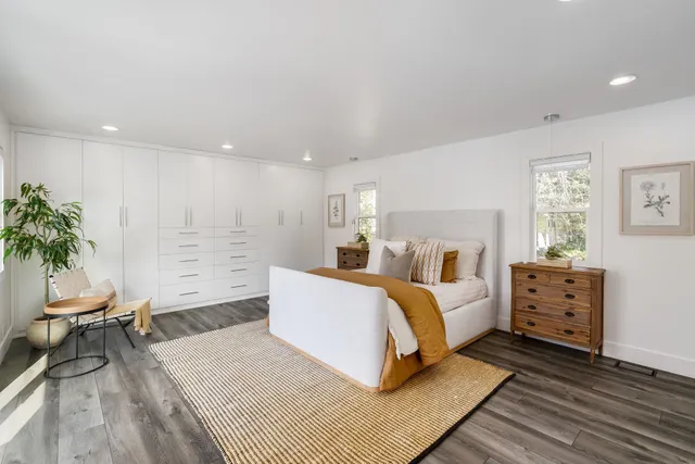 a bed room with a bed and a chair