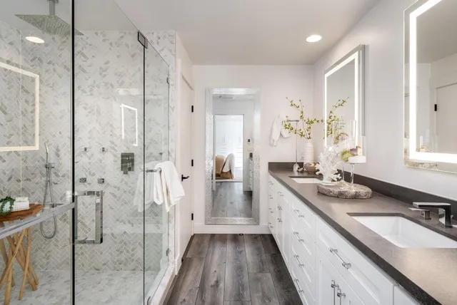 a bathroom with a double vanity sink mirror double and shower