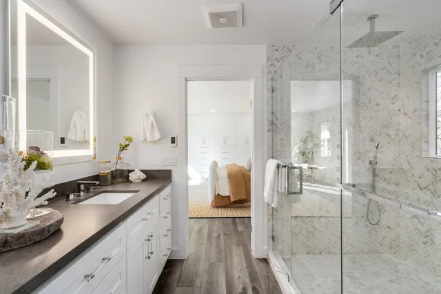 a spacious bathroom with a double vanity sink and mirror