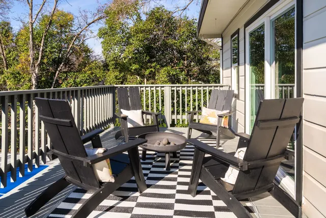 a view of balcony with wooden floor and outdoor seating