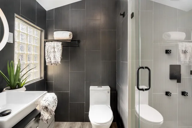 a bathroom with a toilet sink and shower