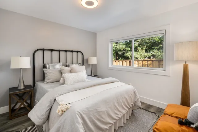 a bed sitting in a bedroom next to a window