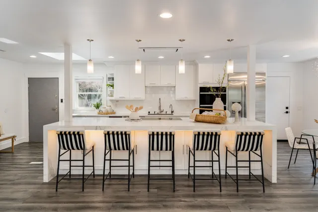 a kitchen with kitchen island wooden cabinets and counter space
