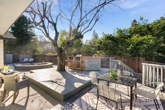 a view of a house with a tub and couches chairs