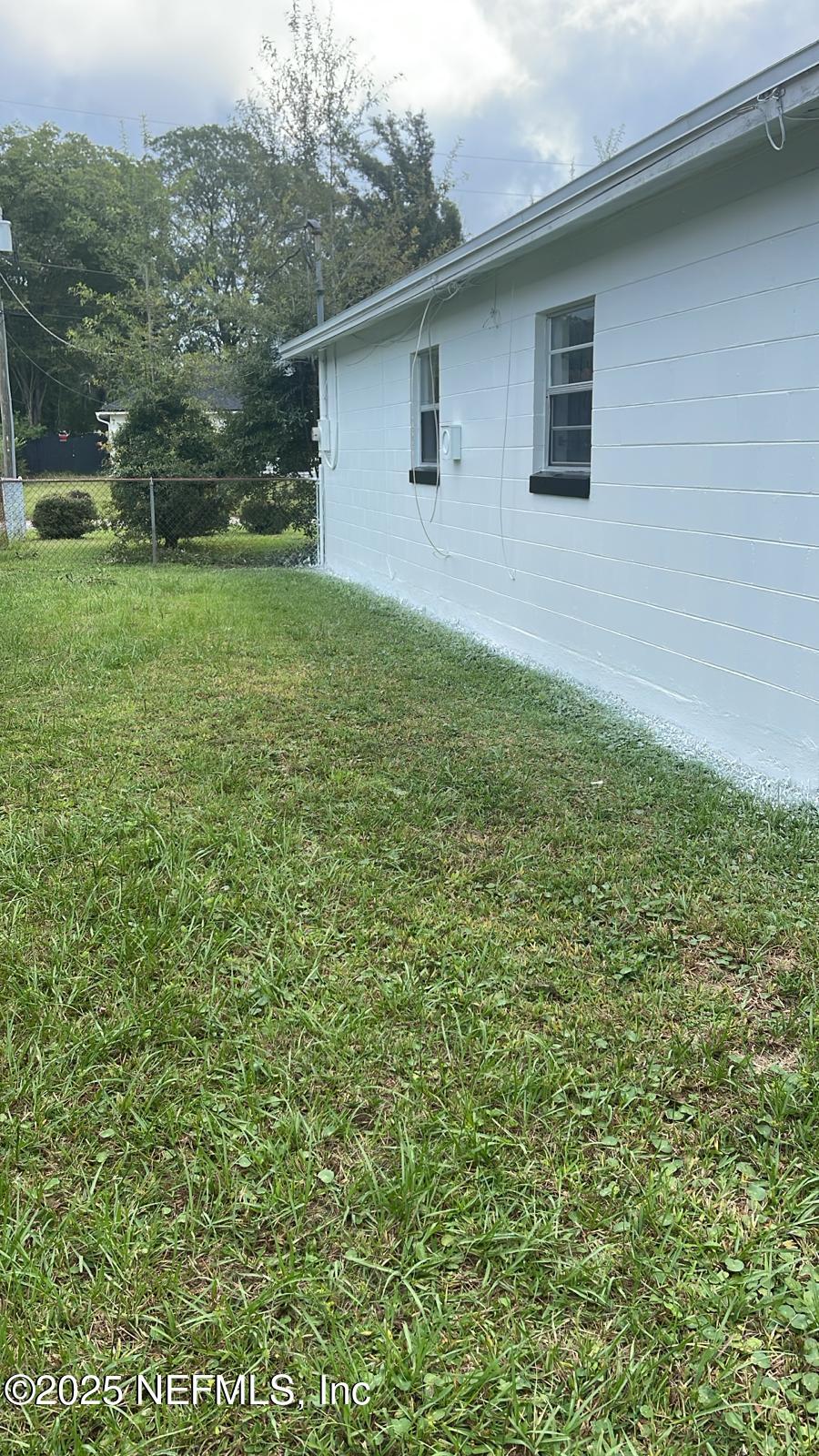 9504 Flechette Avenue Jacksonville, FL 32208 - Photo 14 of 14 a backyard of a house with lots of green space