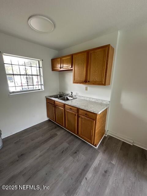 9504 Flechette Avenue Jacksonville, FL 32208 - Photo 3 of 14 a kitchen with wooden floors and wooden cabinets