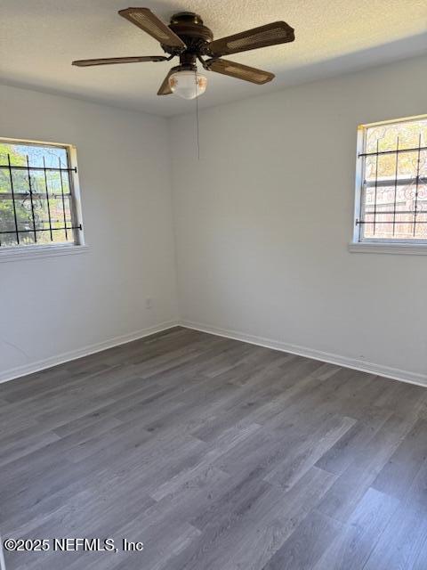 9504 Flechette Avenue Jacksonville, FL 32208 - Photo 10 of 14 an empty room with wooden floor fan and windows