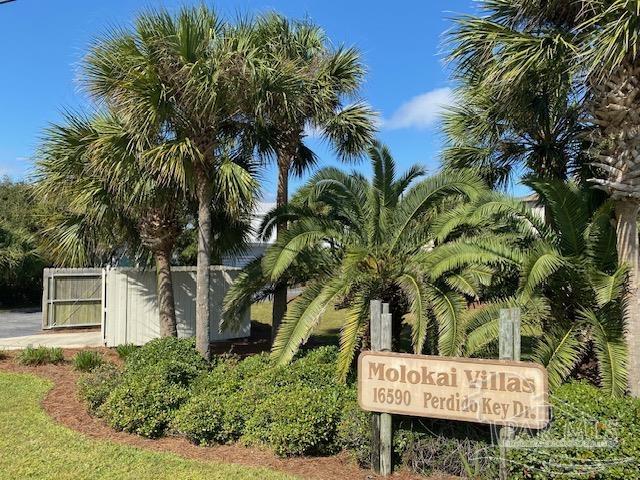 16590 Perdido Key Drive, Unit 5A Perdido Key, FL 32507 - Photo 1 of 24 a sign that is sitting in front of a house with a tree