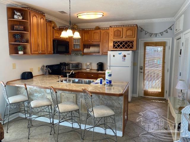 16590 Perdido Key Drive, Unit 5A Perdido Key, FL 32507 - Photo 3 of 24 a kitchen with granite countertop a stove a sink and a refrigerator