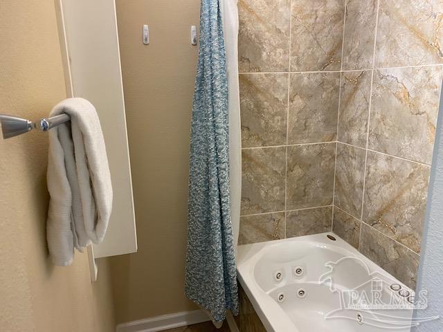 16590 Perdido Key Drive, Unit 5A Perdido Key, FL 32507 - Photo 6 of 24 a bathroom with a bathtub and shower