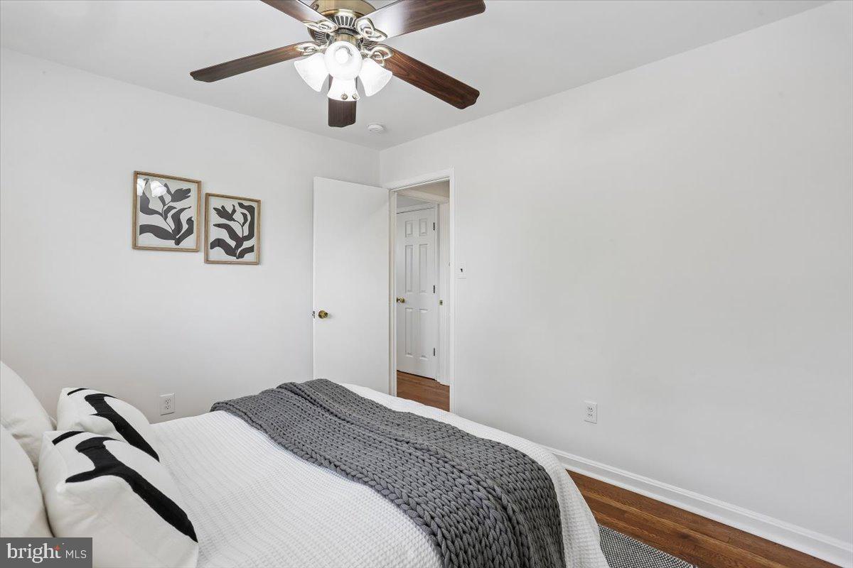 3709 Kenway Street Silver Spring, MD 20906 - Photo 25 of 34 a bedroom with a bed and a chandelier