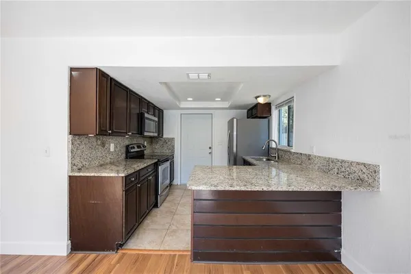a kitchen with a sink and a stove top oven
