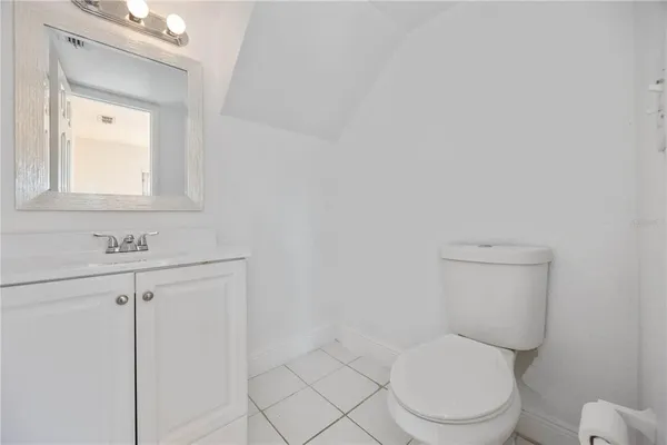 a white toilet sitting next to a bathroom sink