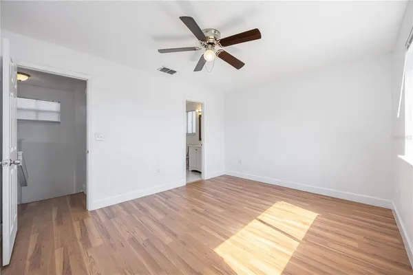 a view of empty room with wooden floor