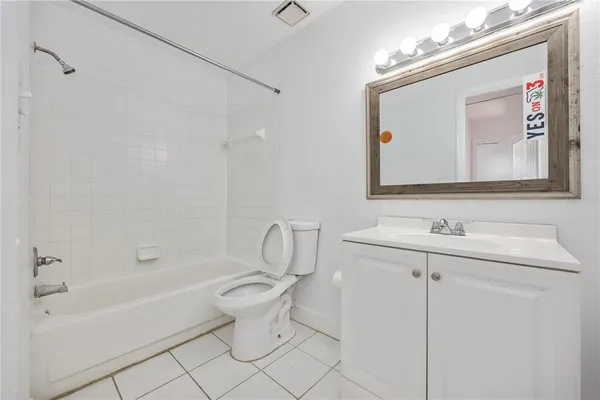 a bathroom with a toilet a sink a mirror and a bathtub