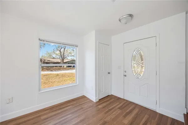 a view of an entryway with wooden floor
