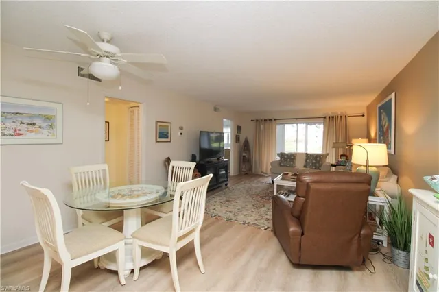 a view of a dining room with furniture and window