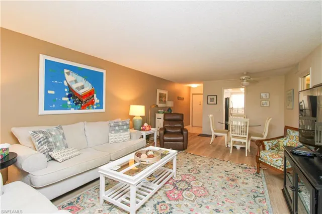 a living room with furniture a rug and a flat screen tv