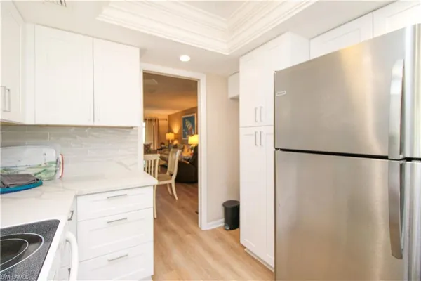 a kitchen with a refrigerator a stove and a sink