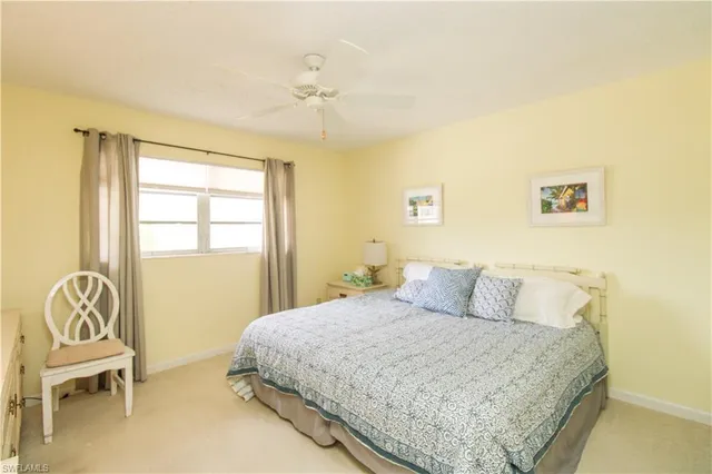 a bedroom with a bed and a chair