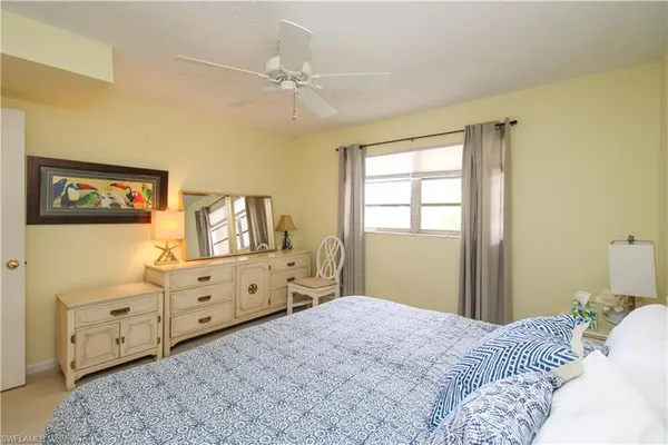 a bedroom with a bed and a dresser in it