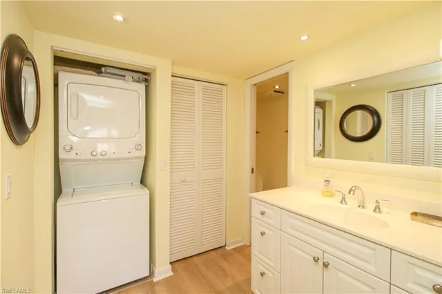 a bathroom with a granite countertop sink toilet and a mirror