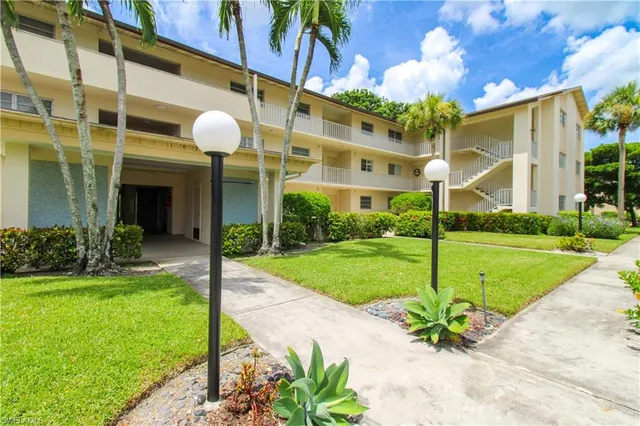 a view of a fountain in front of a brick building