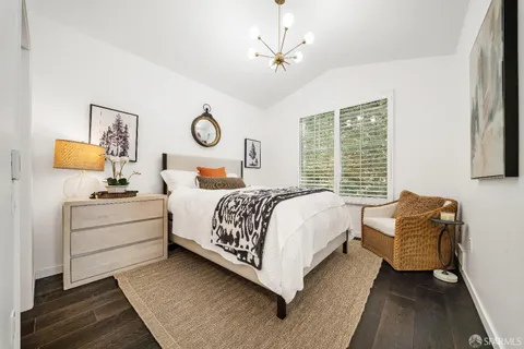 a bed room with a bed and a chair