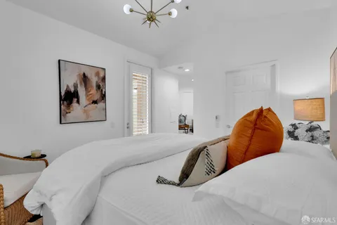a bedroom with a bed and a painting on the wall