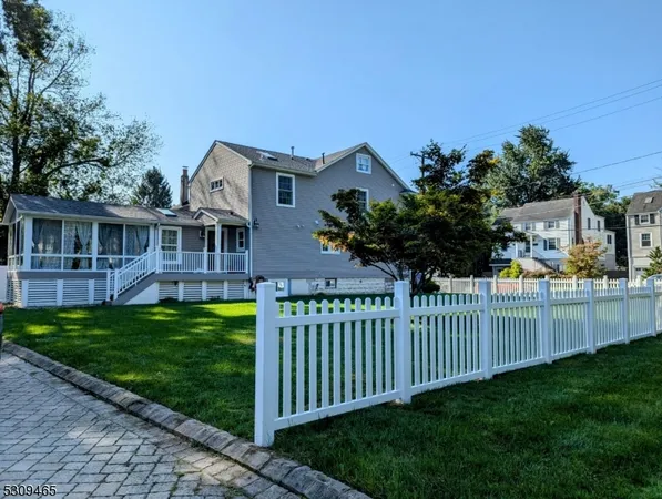 a view of a house with backyard and porch