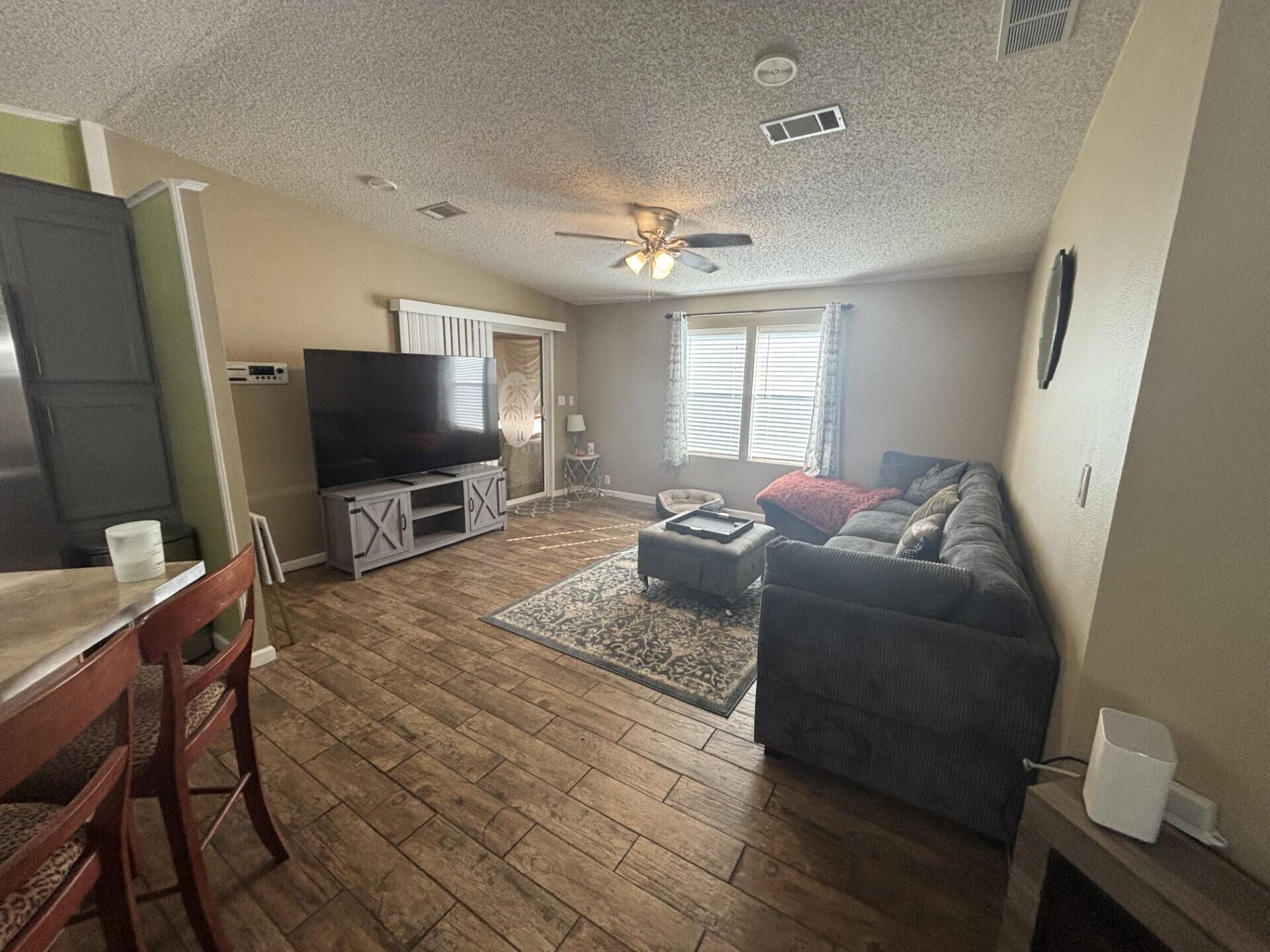 6567 Northwest 34th Avenue Pompano Beach, FL 33073 - Photo 11 of 30 a living room with furniture and a flat screen tv