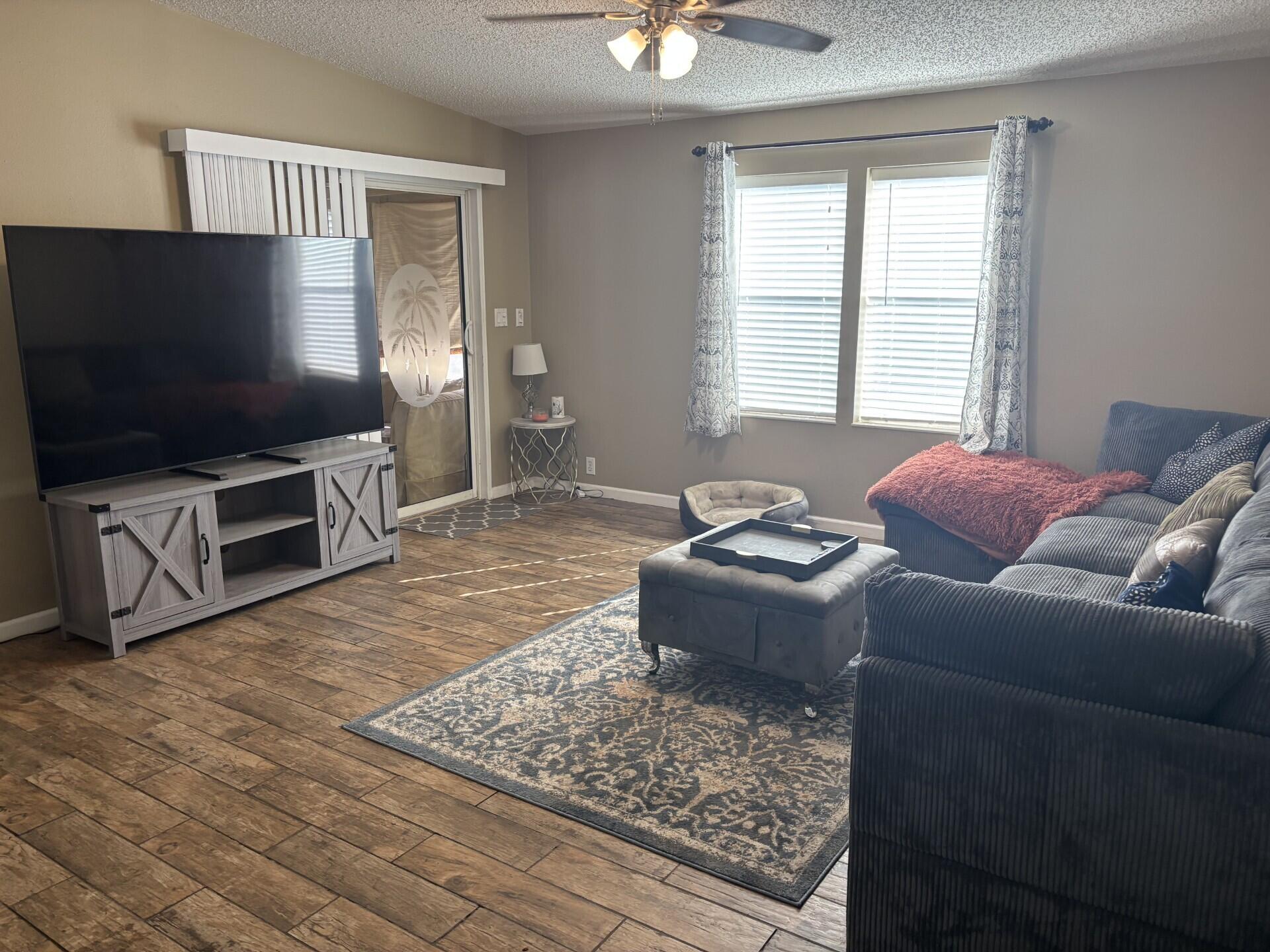 6567 Northwest 34th Avenue Pompano Beach, FL 33073 - Photo 12 of 30 a living room with furniture and a flat screen tv